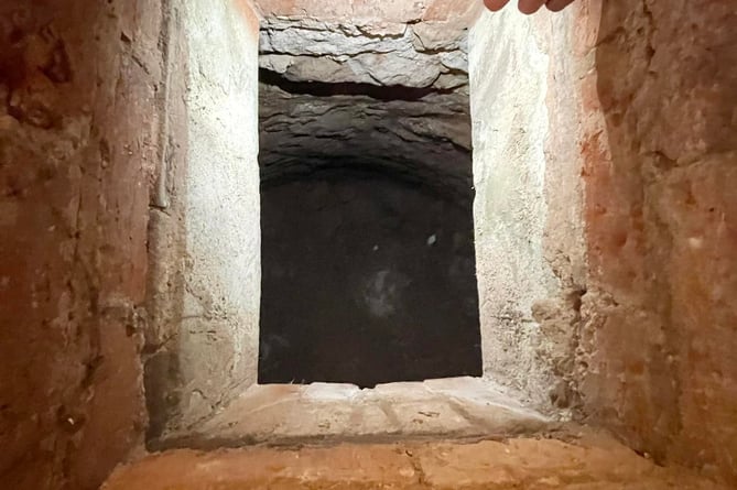 Looking down into a hidden cellar.