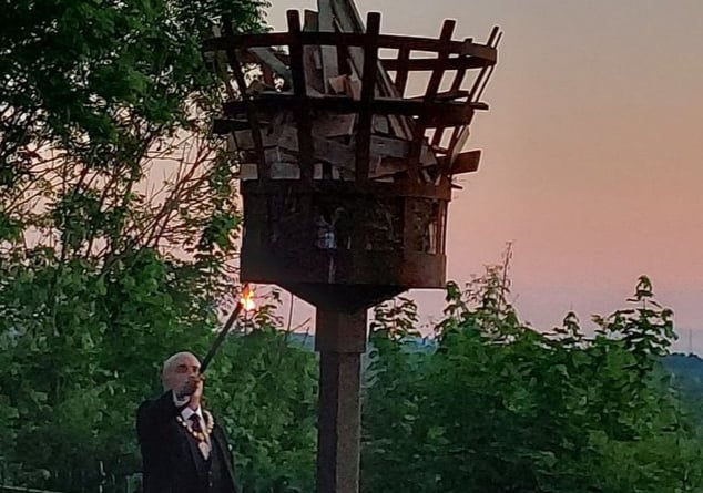 A photo of Ross mayor Ed O’Driscoll lighting the beacon on the Prospect at sunset.