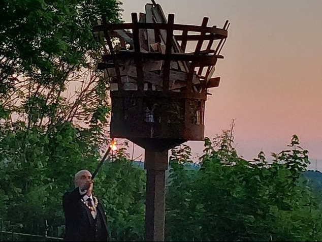 A photo of Ross mayor Ed O’Driscoll lighting the beacon on the Prospect at sunset.