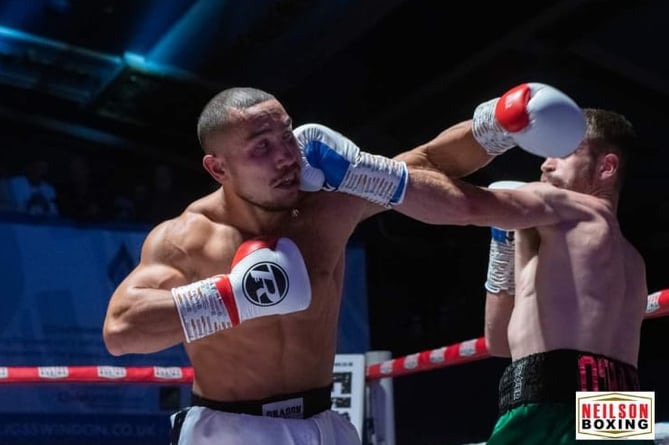 Boxer Liam O’hare ducking a haymaker (punch) and landing a blow to his opponent.