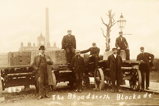 A postcard of the ‘Broadheath Blockade’ showing a printers strike with wagons loaded with stones blocking the entrance to the Linotype factory. It clearly illustrates that history repeats itself as workers today are going on strike for higher pay