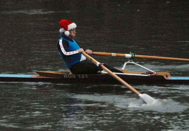 Mike Jones puts his back into it wearing a Santa hat