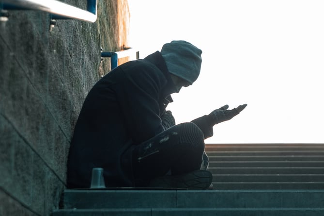 A man, homeless, a person asks for alms on the street with a Help sign. concept of homelessness, social problem, drug addict, poverty, despair