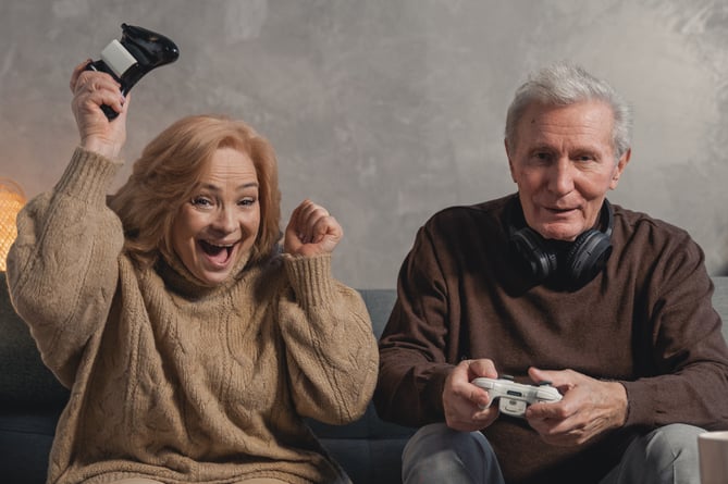 A woman and a man playing video games