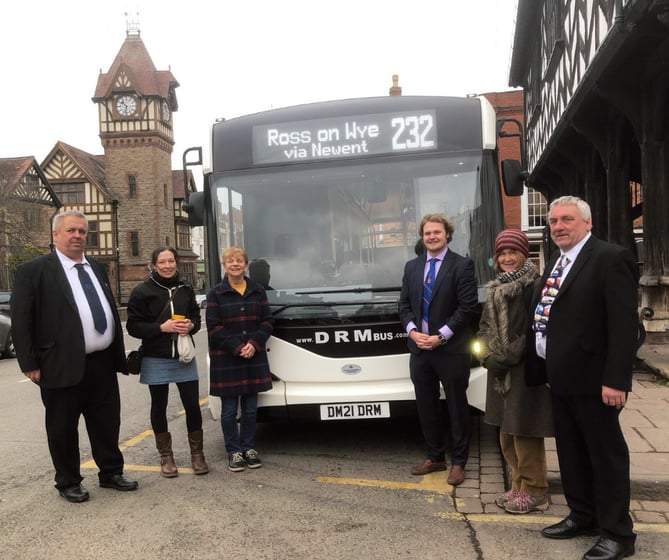 Staff and volunteers next to the new 232 bus