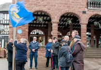 Commonwealth spirits un-dampened by weather during flag raising