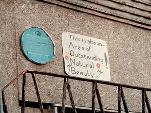 Sign of the times: blue plaque’s new neighbour