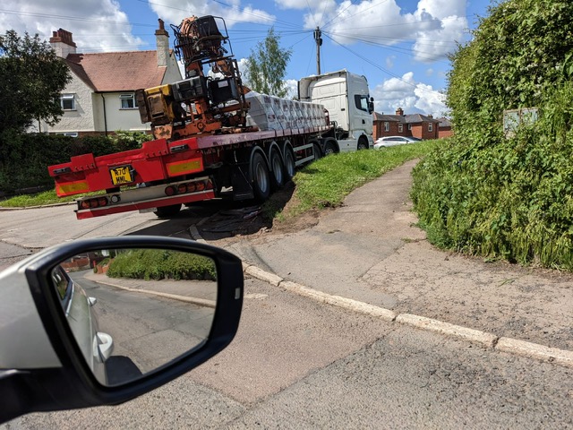 A HGV driving over a grass verge on Middleston Avenue