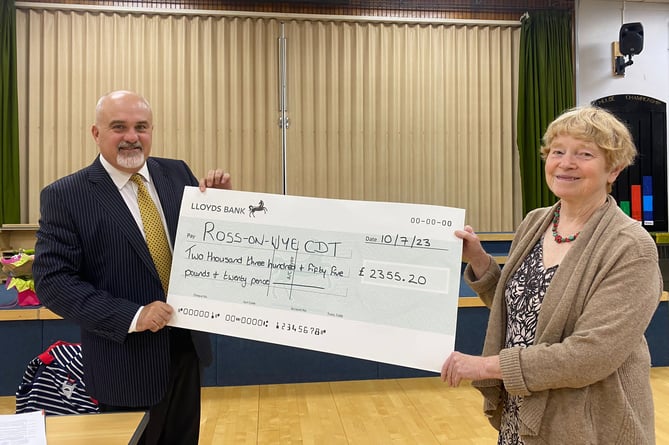 Former mayor Ed O'Driscoll handing a large cheque to - another - former mayor Jane Roberts