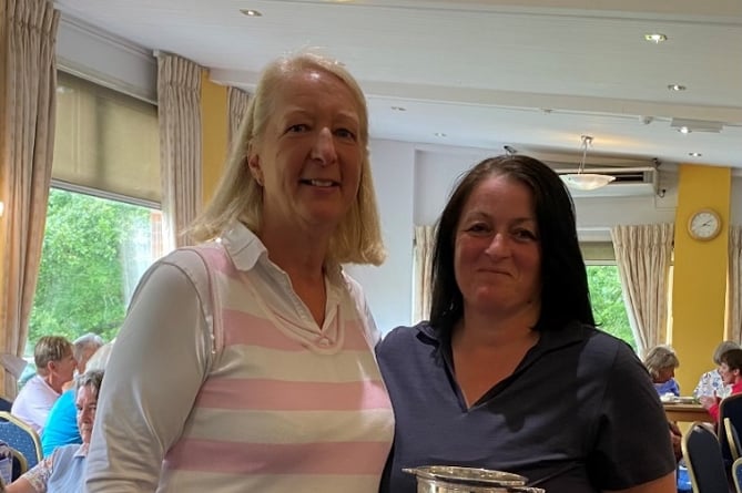 Lois Price receiving her trophy for winning the Nett Championship Strokeplay Competition from Katie Stooke Ladies Captain