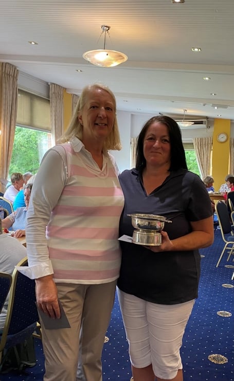 Lois Price receiving her trophy for winning the Nett Championship Strokeplay Competition from Katie Stooke Ladies Captain