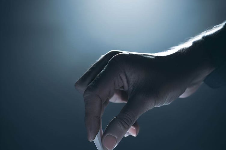 A hand casting a vote