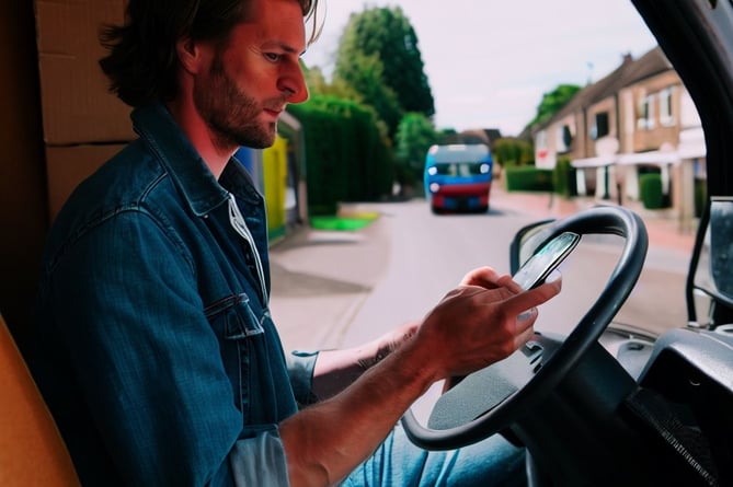 Man using phone at wheel