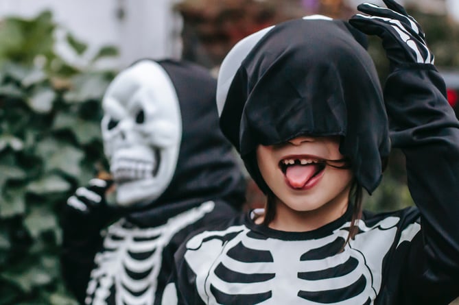 A child in a skeleton Halloween costume