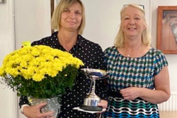 Kerry Welding is presented with the Josie Powell Trophy from Ross-on-Wye GC ladies captain Katie Stooke