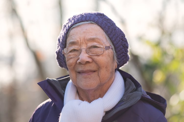 Healthy 92 year old independent Chinese woman taking a winter walk.  North Vancouver, British Columbia, Canada.