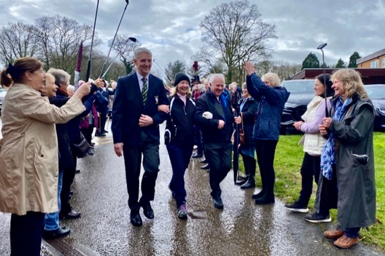 Incoming Ross-on-Wye Golf Club Lady Captain Lorraine Fenner escorted by Club Captain Stephen Price (left) and husband Martin Fenner (right) head to first tee for her drive in