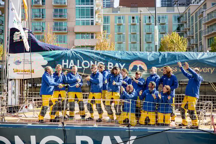 Cue champagne as Eric, third from left, and crew open the bubbly