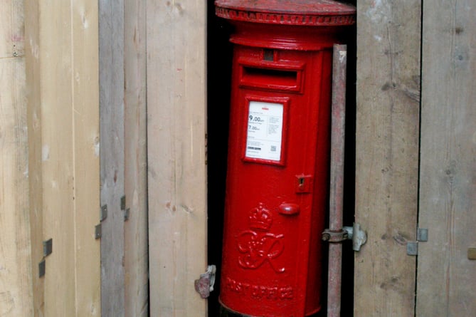 Postbox surrounded by wooden planking