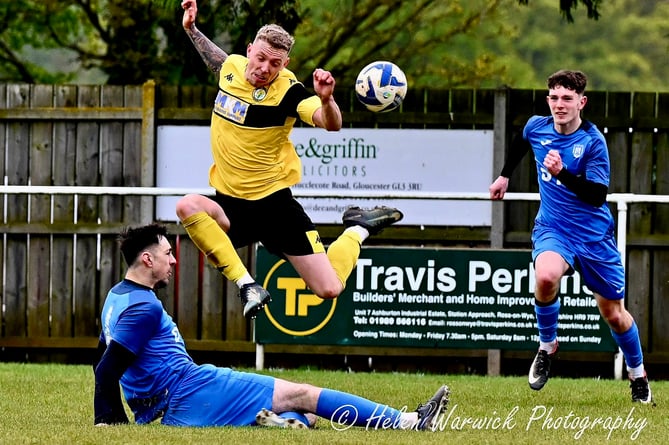 A Newent Town player jumps for the ball. Photo: Helen Warwick Photography