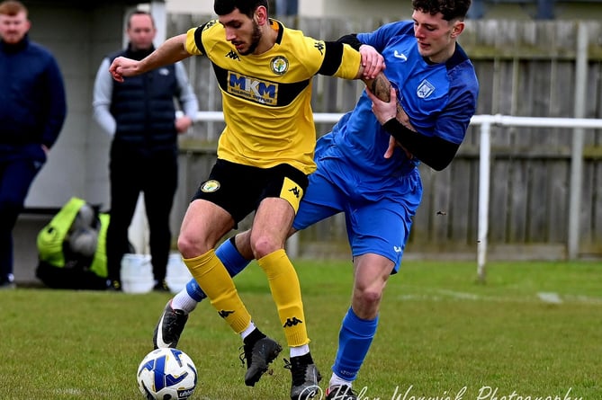 A Newent player shields the ball. Photo: Helen Warwick Photography