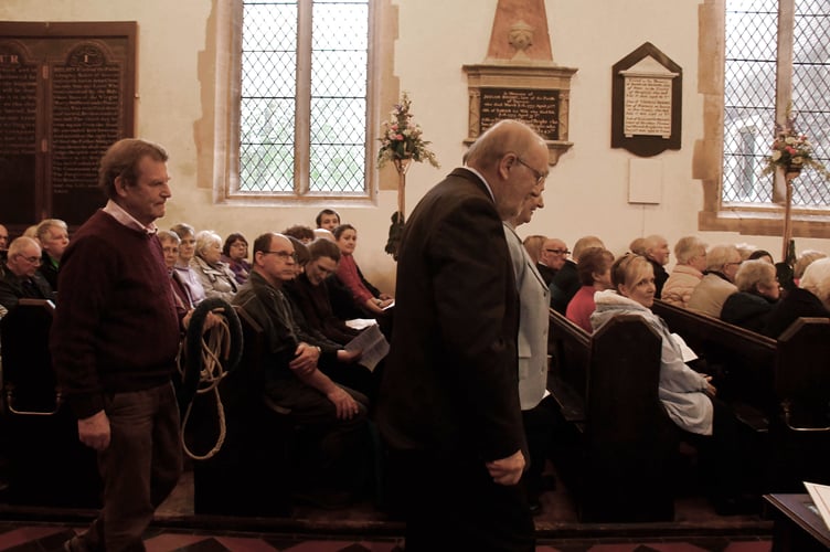 Churchwardens John Moseley and Carryl Phelps and tower captain Herbie Renfield take a bell rope to be blessed.