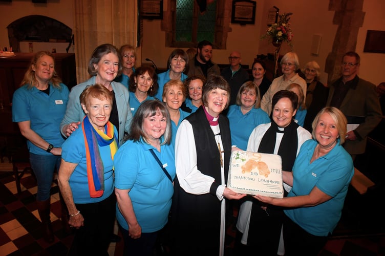 Bishop Rachel and Rev Lara Bloom with the Friends of Longhope Church and a celebration cake which is also being held by Friends' Chair Tina Coull.