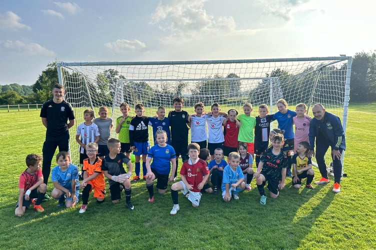 Former Arsenal midfield David Hillier (right) is pictured with some of the Ross Juniors players he coached as part of the club's 20th anniversary celebrations.  Image by Paul Flitney (Ross Juniors FC).
