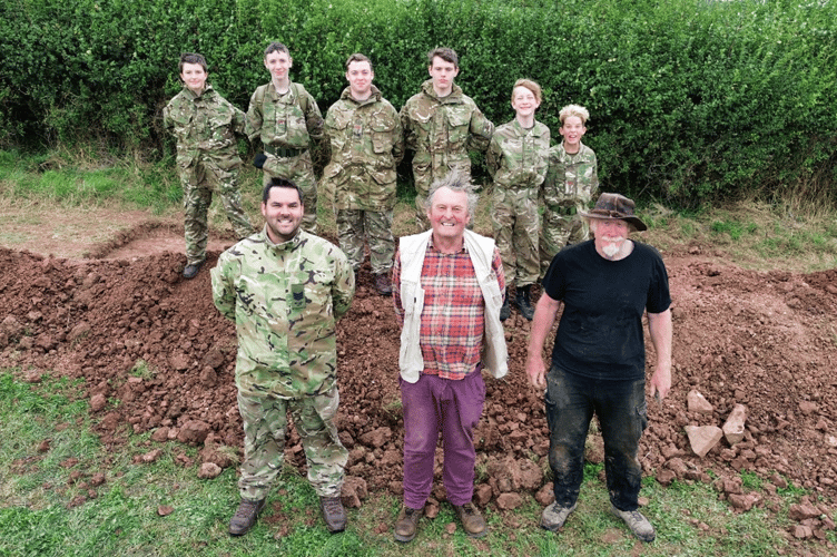 Cadets from C Company, Gloucestershire Army Cadet Force stand in front of their trench with Serjeant Instructor Ben Trimble, Professor Mark Horton and Chris Splotte from the Royal Agricultural University