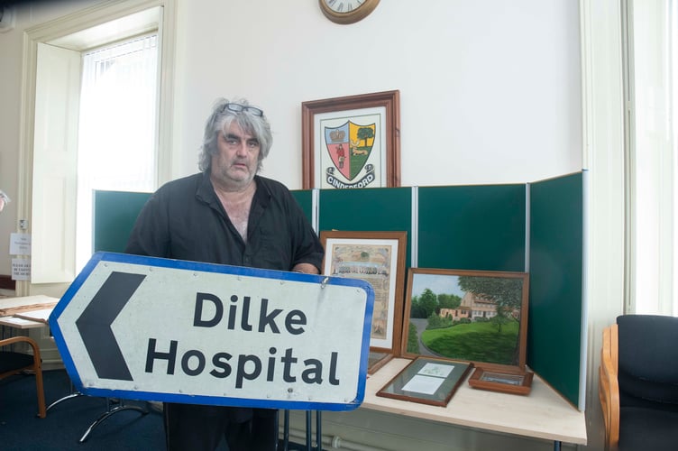 Cinderford Town councillor Mark Turnerr with a Dilke Hospital road sign that is now in the town archive.