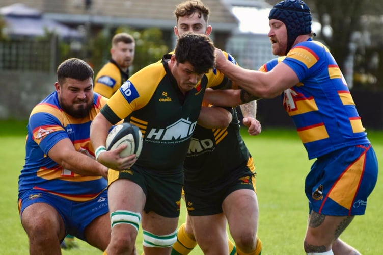 A Newent player drives forward