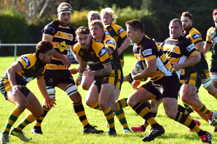 A Shipston player finds his way blocked by Newent defenders