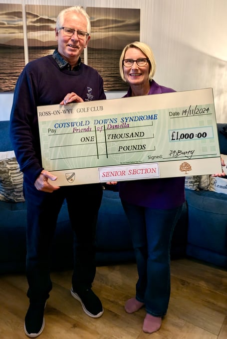 Seniors Captain Paul Burry presents the cheque to Jenny King