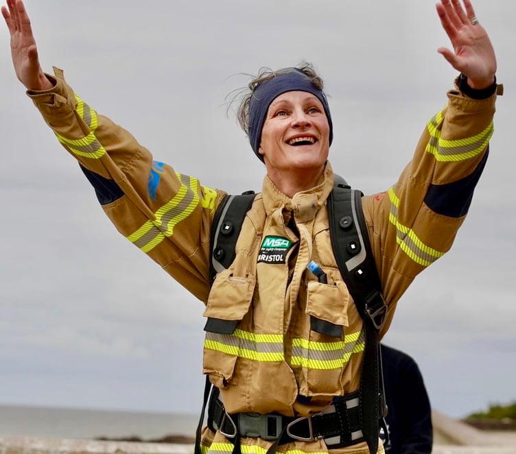 George Gilbert salutes after completing her epic marathon challenge