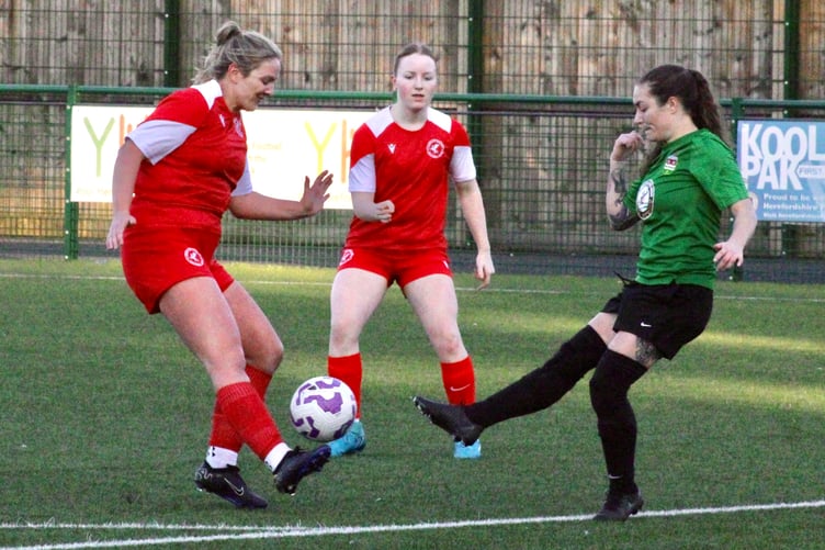 A Juniors player challenges a Pegasus player for the ball