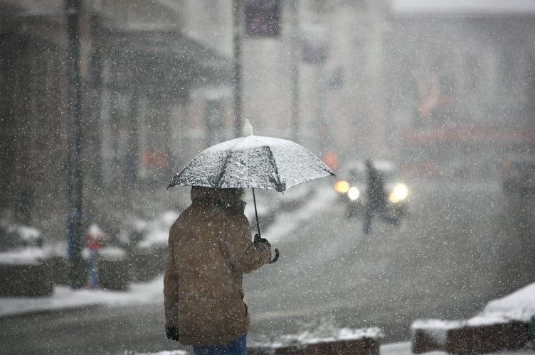 Man with umbrella during snow storm in the street
