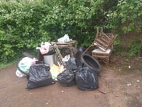 Black bags, furniture, a tyre and bike parts dumped near donation bin