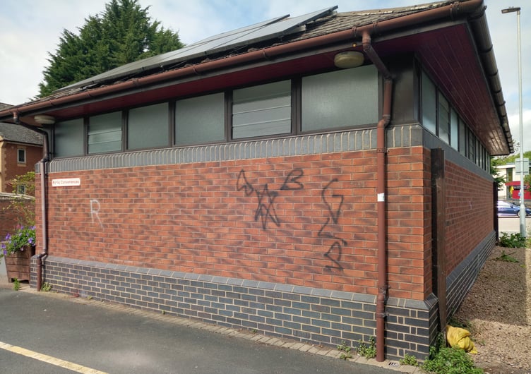 Toilet block with graffiti.