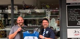 Butcher presented with framed shirt after proving cut above
