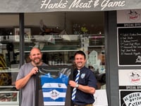 Butcher presented with framed shirt after proving cut above
