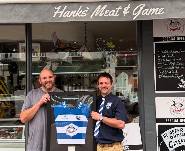Butcher presented with framed shirt after proving cut above