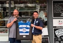 Butcher presented with framed shirt after proving cut above