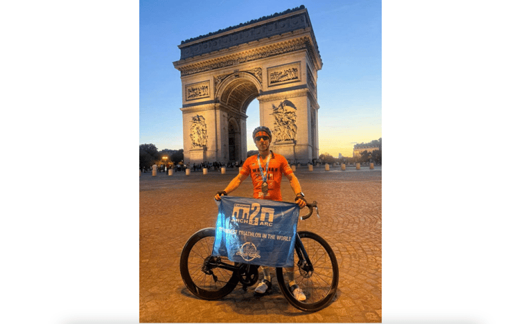 Sam Weale in front of the Arc de Triomphe after completing his epic challenge. Photo: Sam Weale