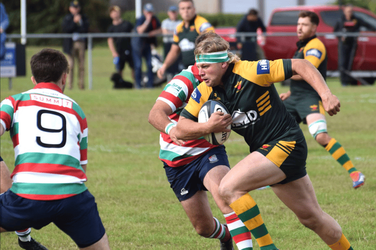 A Newent player charges at the Lutterworth defence