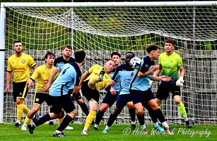 A Daffs player tries his luck with an overhead effort in a crowded box