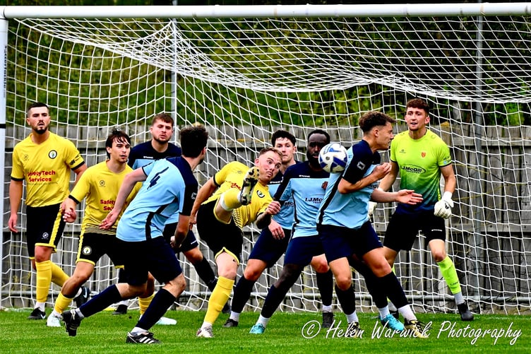A Daffs player tries his luck with an overhead effort in a crowded box