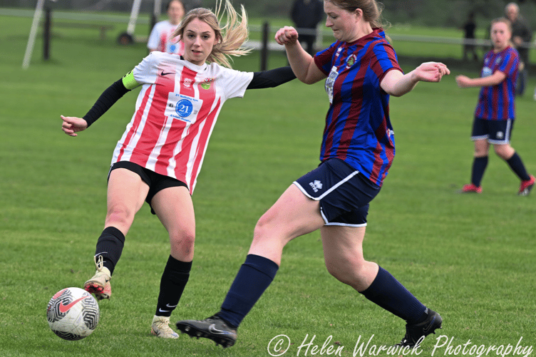 A Ross player gets their foot to the ball first
