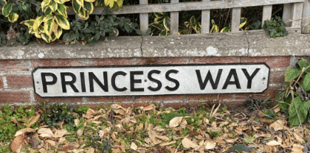 Volunteers brighten street with sign makeover