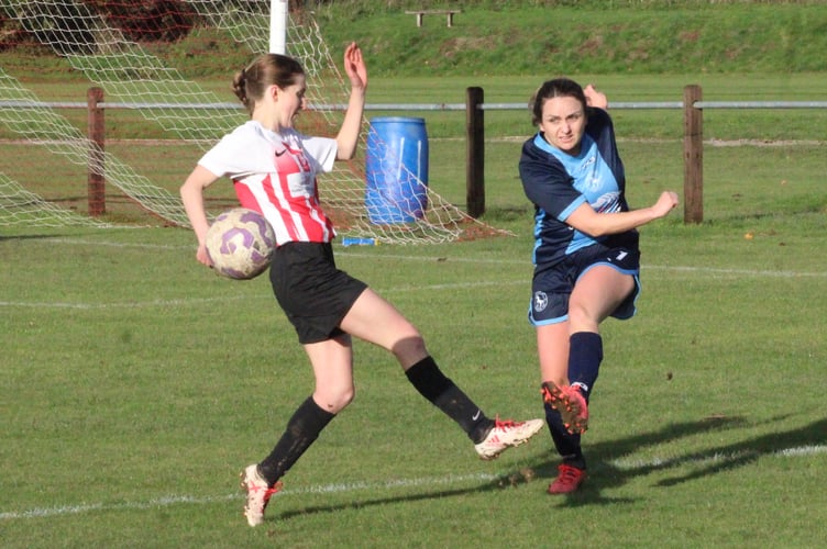 A Penybont player gets a shot off
