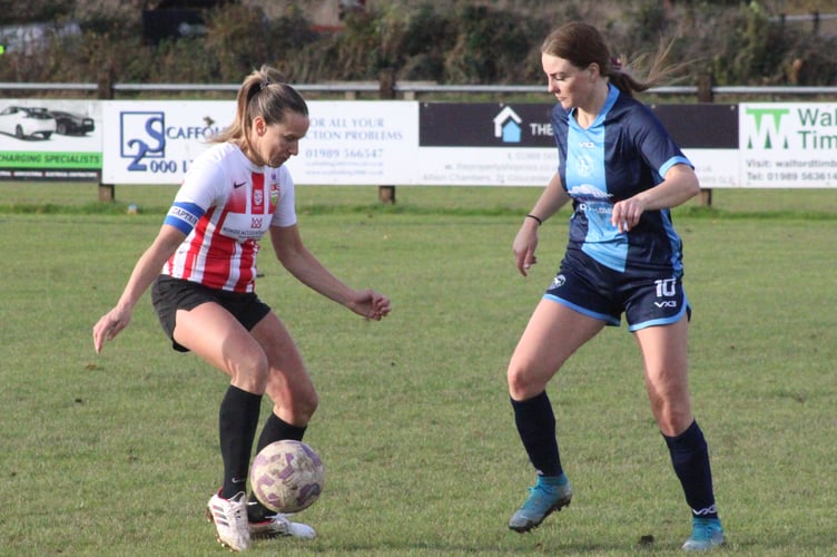 A Juniors player takes on a Penybont opponent